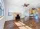 Spacious living room boasting hardwood floors, modern ceiling fans, a fireplace and views into the kitchen at 4219 4Th S Ave, St Petersburg, FL 33711