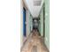 Long hallway with green walls and rustic wood flooring at 4530 Country Hills Blvd, Plant City, FL 33563