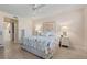 Bright bedroom with king-size bed, dresser, and hardwood floors at 5095 Bay Ne St # 117, St Petersburg, FL 33703