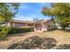 Ranch style home with mature landscaping and a covered front porch at 5117 Roanoke Dr, Holiday, FL 34690