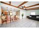 Open living area with wood beam ceilings and tile flooring at 5117 Roanoke Dr, Holiday, FL 34690