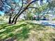 Apartment building with pond and lush landscaping at 5265 E Bay Dr # 410, Clearwater, FL 33764