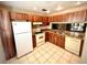 Kitchen with wood cabinets, granite countertops, and stainless steel appliances at 5265 E Bay Dr # 410, Clearwater, FL 33764