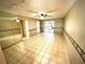 Spacious living room with tiled floors and mirrored walls at 5265 E Bay Dr # 410, Clearwater, FL 33764