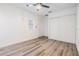 Bright bedroom featuring wood-look floors and double-door closet at 5923 Bitterwood Ct, Tampa, FL 33625