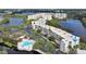 Aerial view of waterfront condo building with pool and lush landscaping at 6315 Shoreline Dr # 3208, St Petersburg, FL 33708