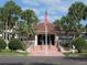 Community building with flag and landscaping at 6315 Shoreline Dr # 3208, St Petersburg, FL 33708
