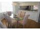 Elegant dining room with glass-top table and pink chairs at 6315 Shoreline Dr # 3208, St Petersburg, FL 33708