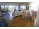 Dining area with glass table and pink chairs, adjacent to the living room at 6315 Shoreline Dr # 3208, St Petersburg, FL 33708