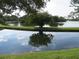 Serene lake with lush landscaping and reflection at 6315 Shoreline Dr # 3208, St Petersburg, FL 33708