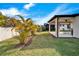 Well-maintained backyard with covered patio, lush lawn, and tropical landscaping for outdoor enjoyment at 6449 Mooring Line Cir, Apollo Beach, FL 33572