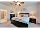 Comfortable bedroom with an ensuite bathroom and a dark wood dresser with drawers and lighting at 6449 Mooring Line Cir, Apollo Beach, FL 33572