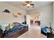 Cozy bedroom with a ceiling fan, wood flooring, and fun dinosaur decorations on the walls at 6449 Mooring Line Cir, Apollo Beach, FL 33572