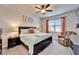 Relaxing bedroom with a ceiling fan, a plush chair and a large window offering natural light at 6449 Mooring Line Cir, Apollo Beach, FL 33572