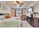 Inviting bedroom with a ceiling fan, large window views and a comfortable chair at 6449 Mooring Line Cir, Apollo Beach, FL 33572