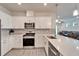 Bright kitchen with stainless appliances, and a view to the dining area and living room at 6449 Mooring Line Cir, Apollo Beach, FL 33572