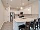 Bright kitchen features stainless steel appliances, quartz countertops and a breakfast bar with seating at 6449 Mooring Line Cir, Apollo Beach, FL 33572