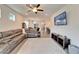 Bright living room featuring a large sectional sofa and a view of the dining area at 6449 Mooring Line Cir, Apollo Beach, FL 33572