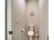 Neutral powder room featuring clean lines, simple artwork, and convenient toilet paper holder at 6449 Mooring Line Cir, Apollo Beach, FL 33572