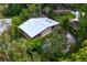 An aerial view showcasing a mid-century home nestled in tropical foliage at 711 Pinellas Point S Dr, St Petersburg, FL 33705