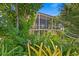 Mid-century modern home nestled in a tropical garden setting at 711 Pinellas Point S Dr, St Petersburg, FL 33705