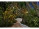 Stone pathway winding through a lush tropical garden at night at 711 Pinellas Point S Dr, St Petersburg, FL 33705