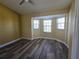 Bright bedroom featuring a bay window and wood-look flooring at 8222 Brent St, Port Richey, FL 34668