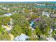 Aerial view of the property with a colorful arrow pointing towards the house surrounded by trees at 828 17Th N Ave, St Petersburg, FL 33704