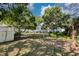 Large, grassy backyard featuring mature trees, a white picket fence, and a well-maintained lawn at 828 17Th N Ave, St Petersburg, FL 33704