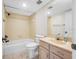 Clean bathroom with beige tile, vanity, and bathtub at 828 Bahia Del Sol Dr # 59/ A, Ruskin, FL 33570