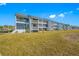Two-story building with multiple units and balconies overlooking a grassy area at 828 Bahia Del Sol Dr # 59/ A, Ruskin, FL 33570