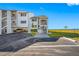Condo building's exterior showing parking and ocean views at 828 Bahia Del Sol Dr # 59/ A, Ruskin, FL 33570