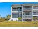 Two-story building with multiple units and balconies showcasing the building's exterior at 828 Bahia Del Sol Dr # 59/ A, Ruskin, FL 33570