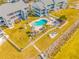 Aerial view of condo community with inviting pool, lush landscaping, and waterfront access at 828 Bahia Del Sol Dr # 59/ A, Ruskin, FL 33570