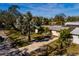Single-story home with driveway and tropical landscaping at 8349 41St N Ave, St Petersburg, FL 33709