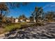 Ranch style home with teal door and tropical landscaping at 8349 41St N Ave, St Petersburg, FL 33709