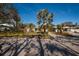 Ranch style home with teal door and tropical landscaping at 8349 41St N Ave, St Petersburg, FL 33709