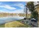 Lake view from backyard patio with grill and seating at 9111 Moonlit Meadows Loop, Riverview, FL 33578