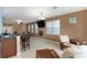 Open living space with kitchen island and seating at 9111 Moonlit Meadows Loop Loop, Riverview, FL 33578