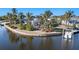 Waterfront property surrounded by palm trees and lush landscaping at 103 Rodgers Ne Ave, Port Charlotte, FL 33952