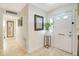 Light and airy entryway with tile flooring and a coat rack at 103 Rodgers Ne Ave, Port Charlotte, FL 33952