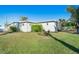 Side view of house showcasing landscaping and exterior details at 103 Rodgers Ne Ave, Port Charlotte, FL 33952