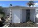 Exterior view of a storage building with landscaping, perfect for storage or a workshop at 103 Rodgers Ne Ave, Port Charlotte, FL 33952