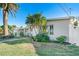 Single story home with landscaped lawn and palm trees at 103 Rodgers Ne Ave, Port Charlotte, FL 33952