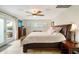 Bright main bedroom with king-size bed and access to patio at 103 Rodgers Ne Ave, Port Charlotte, FL 33952