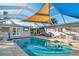 Relaxing screened-in pool and patio area with a large shade sail at 103 Rodgers Ne Ave, Port Charlotte, FL 33952