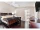 Main bedroom with a king-size bed and dark wood furniture at 10442 Bloomfield Hills Dr, Seffner, FL 33584