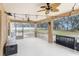 Spacious screened porch with ceiling fan and string lights at 10442 Bloomfield Hills Dr, Seffner, FL 33584