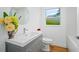 Simple bathroom with single vanity, grey cabinet, and bathtub at 1061 Sedeeva St, Clearwater, FL 33755