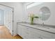 Modern bathroom with double vanity, grey countertops, and large mirrors at 1061 Sedeeva St, Clearwater, FL 33755